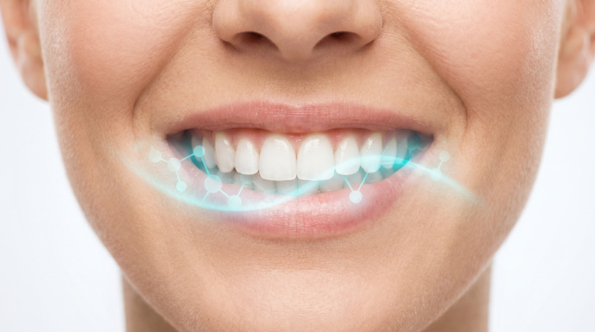 Close-up of a healthy smile with a teal molecular wave representing pH-balanced treatment for bad breath caused by wisdom teeth.